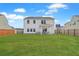 Large backyard with a lush lawn, patio set, and privacy fence, ideal for entertaining at 306 Lucca Dr, Summerville, SC 29486