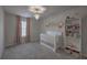 Bedroom featuring a white crib, decorative wall art, and a bookshelf filled with accessories at 306 Lucca Dr, Summerville, SC 29486