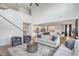 Spacious living room with open layout, large windows, and modern furnishings leading to kitchen at 306 Lucca Dr, Summerville, SC 29486
