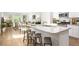 Open-concept kitchen with an island, granite countertops, and stainless steel appliances at 326 Tiliwa St, Summerville, SC 29486