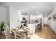Sunlit kitchen with light wood floors, white cabinets, granite countertops and stainless steel appliances at 326 Tiliwa St, Summerville, SC 29486