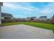 Spacious backyard with a concrete patio and a well-maintained lawn surrounded by a wooden fence at 330 Bountiful Dr, Moncks Corner, SC 29461