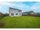 This spacious backyard includes a well-manicured lawn, wood fencing, and patio at 330 Bountiful Dr, Moncks Corner, SC 29461