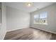 A bright, airy bedroom with wood-look floors and a large window offering natural light and outdoor views at 330 Bountiful Dr, Moncks Corner, SC 29461
