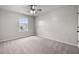 Bright bedroom featuring neutral walls, plush carpeting, a ceiling fan, and a window for natural light at 330 Bountiful Dr, Moncks Corner, SC 29461