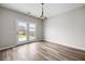 Bright dining area with chandelier and view of the backyard through double glass doors at 330 Bountiful Dr, Moncks Corner, SC 29461