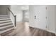 A welcoming foyer features stylish flooring, a staircase with wood treads, and an inviting view of the living space at 330 Bountiful Dr, Moncks Corner, SC 29461