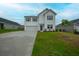 Attractive two-story home with a manicured front lawn, a two-car garage, and a welcoming entrance at 330 Bountiful Dr, Moncks Corner, SC 29461