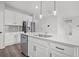 Close-up of a kitchen island with quartz countertops, stainless steel appliances, and pendant lights at 330 Bountiful Dr, Moncks Corner, SC 29461