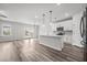 Bright, open-concept kitchen with a central island, modern appliances, and a door to the backyard at 330 Bountiful Dr, Moncks Corner, SC 29461