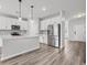 Modern kitchen with white cabinets, stainless steel appliances, quartz countertops, and stylish pendant lighting at 330 Bountiful Dr, Moncks Corner, SC 29461