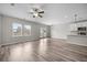 Open-concept living area with ample natural light, hardwood floors, and a view of the kitchen at 330 Bountiful Dr, Moncks Corner, SC 29461