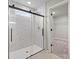 Shower with decorative tile surround, a glass door, and view to walk-in closet at 330 Bountiful Dr, Moncks Corner, SC 29461