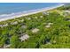 Aerial view of beach homes nestled within lush greenery near the ocean at 3577 Shipwatch Rd, Kiawah Island, SC 29455