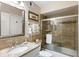 Updated bathroom featuring a glass-enclosed shower, granite counter, and framed mirror at 3577 Shipwatch Rd, Kiawah Island, SC 29455