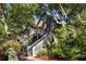 Charming cedar shake home exterior with inviting staircases, lush landscaping, and a rustic appeal at 3577 Shipwatch Rd, Kiawah Island, SC 29455