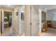 Hallway with bathroom access, tiled flooring, and neutral paint, providing a seamless flow through the home at 3577 Shipwatch Rd, Kiawah Island, SC 29455