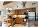 Functional kitchen with wooden cabinets, stainless steel appliances, and adjacent dining area with a unique decorative turtle at 3577 Shipwatch Rd, Kiawah Island, SC 29455