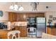 Well-equipped kitchen with stainless steel appliances, wooden cabinetry, and a decorative turtle on the wall at 3577 Shipwatch Rd, Kiawah Island, SC 29455