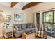 Comfortable living area featuring a cozy couch, striped armchair, and access to an outdoor porch area at 3577 Shipwatch Rd, Kiawah Island, SC 29455