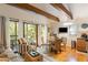 Cozy living room featuring exposed beams, hardwood floors, and a view of nature through sliding glass doors at 3577 Shipwatch Rd, Kiawah Island, SC 29455