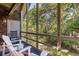 Inviting screened-in porch with Adirondack chairs, providing a cozy and scenic outdoor living space at 3577 Shipwatch Rd, Kiawah Island, SC 29455