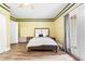 Bright bedroom with a ceiling fan and French doors to the backyard at 4551 Great Oak Dr, North Charleston, SC 29418