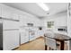 Well-lit kitchen featuring white cabinets, modern appliances, and comfortable dining nook at 4551 Great Oak Dr, North Charleston, SC 29418