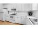 Bright kitchen features all white cabinets and stainless steel appliances at 4551 Great Oak Dr, North Charleston, SC 29418