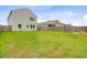 Exterior shot of the backyard of a two-story home with a large grassy area at 490 Pender Woods Dr, Summerville, SC 29486