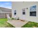 Backyard patio with two white rocking chairs near a white door on a house with white siding at 490 Pender Woods Dr, Summerville, SC 29486