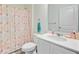 Bright bathroom featuring a shower with colorful curtain, white vanity, and wood-look flooring at 490 Pender Woods Dr, Summerville, SC 29486