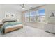 Bright bedroom features three windows, neutral walls, a ceiling fan, and a decorative headboard at 490 Pender Woods Dr, Summerville, SC 29486
