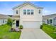 Two-story home with white siding, two-car garage, and landscaped front yard on a sunny day at 490 Pender Woods Dr, Summerville, SC 29486