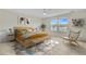 Serene main bedroom with a natural wood bed, bench, stylish accents, and a bright window at 490 Pender Woods Dr, Summerville, SC 29486