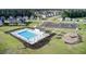 Aerial view of the community pool, clubhouse, playground, and parking lot surrounded by residential homes at 493 Spanish Wells Rd, Summerville, SC 29486