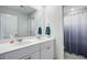 Bathroom featuring a dual sink vanity with large mirror and modern fixtures at 493 Spanish Wells Rd, Summerville, SC 29486