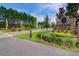Entrance to Lindera Preserve with a brick sign, landscaping, and a well-maintained road at 493 Spanish Wells Rd, Summerville, SC 29486