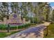 Welcoming entrance sign to the community with well-maintained landscaping and a pathway leading into the neighborhood at 493 Spanish Wells Rd, Summerville, SC 29486
