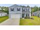 Charming two-story home with a well-maintained lawn and attached two car garage at 493 Spanish Wells Rd, Summerville, SC 29486