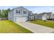 Well-manicured lawn and long driveway leading to a beautiful two-story home at 493 Spanish Wells Rd, Summerville, SC 29486