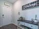 Charming foyer featuring stylish decor, plants, and elegant welcome signs at 493 Spanish Wells Rd, Summerville, SC 29486