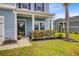 Inviting front porch with beautiful landscaping and a welcoming front door at 493 Spanish Wells Rd, Summerville, SC 29486