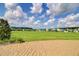 Expansive green space in a residential community under a partly cloudy sky is perfect for outdoor activities at 493 Spanish Wells Rd, Summerville, SC 29486
