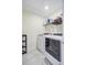 Well-lit laundry room equipped with modern, front-loading washer and dryer and ample shelving at 493 Spanish Wells Rd, Summerville, SC 29486