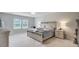 Spacious main bedroom with a decorative bed, large windows, and neutral decor at 493 Spanish Wells Rd, Summerville, SC 29486