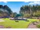 Community playground with a green, frog-themed playset, benches and mature landscaping at 493 Spanish Wells Rd, Summerville, SC 29486