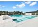 Long community pool with lap lines, lounge chairs and clubhouse with neighborhood in the background at 493 Spanish Wells Rd, Summerville, SC 29486