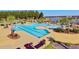 Beautiful community pool with several pools, sunning deck, and tropical landscaping with a lake in the background at 493 Spanish Wells Rd, Summerville, SC 29486