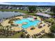 Aerial view of a community pool featuring ample seating, palm trees, and a bath house at 493 Spanish Wells Rd, Summerville, SC 29486